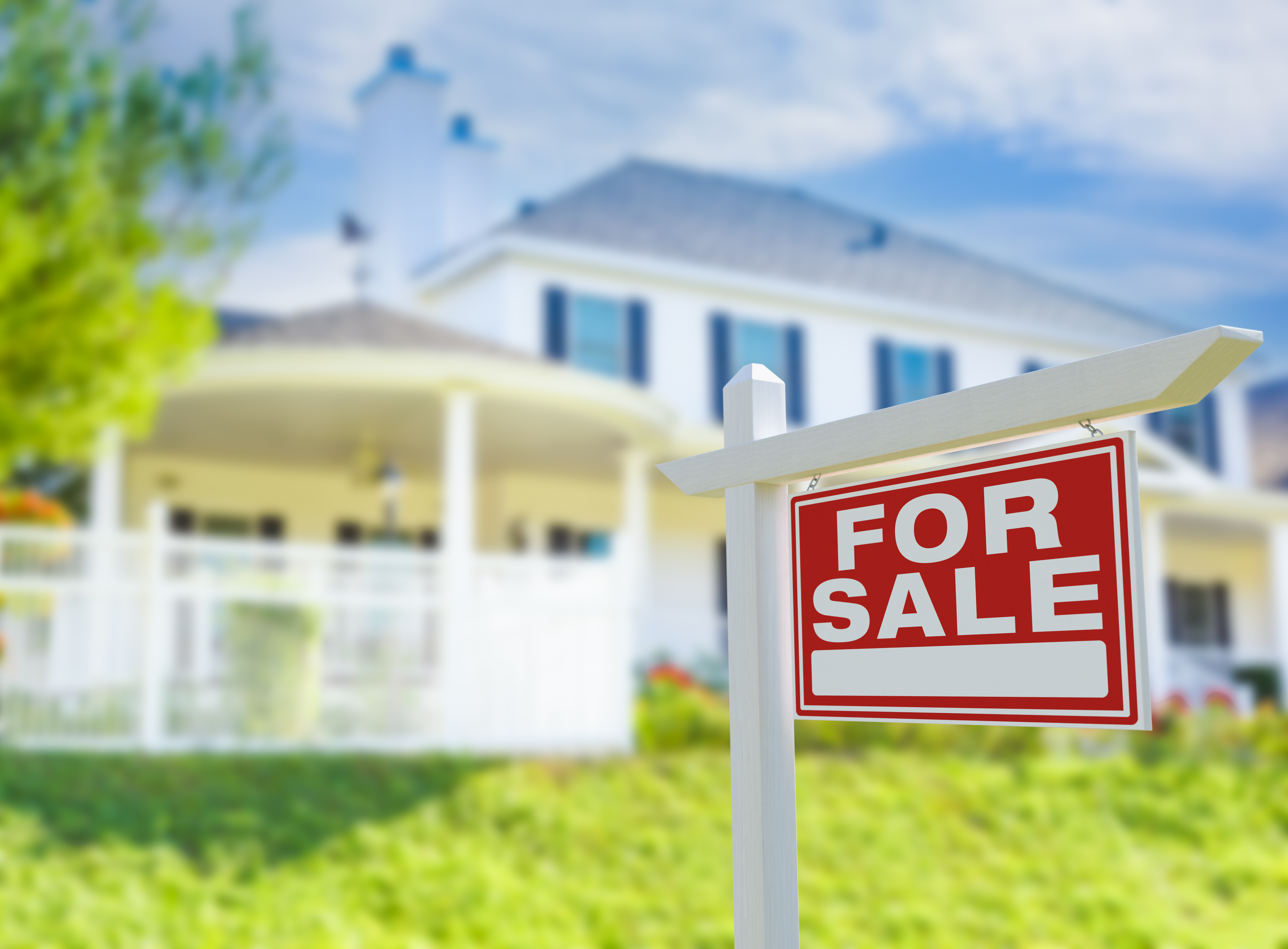 A home with a for sale sign in the yard